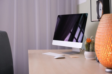 Photo of Comfortable workplace with computer on desk in home office