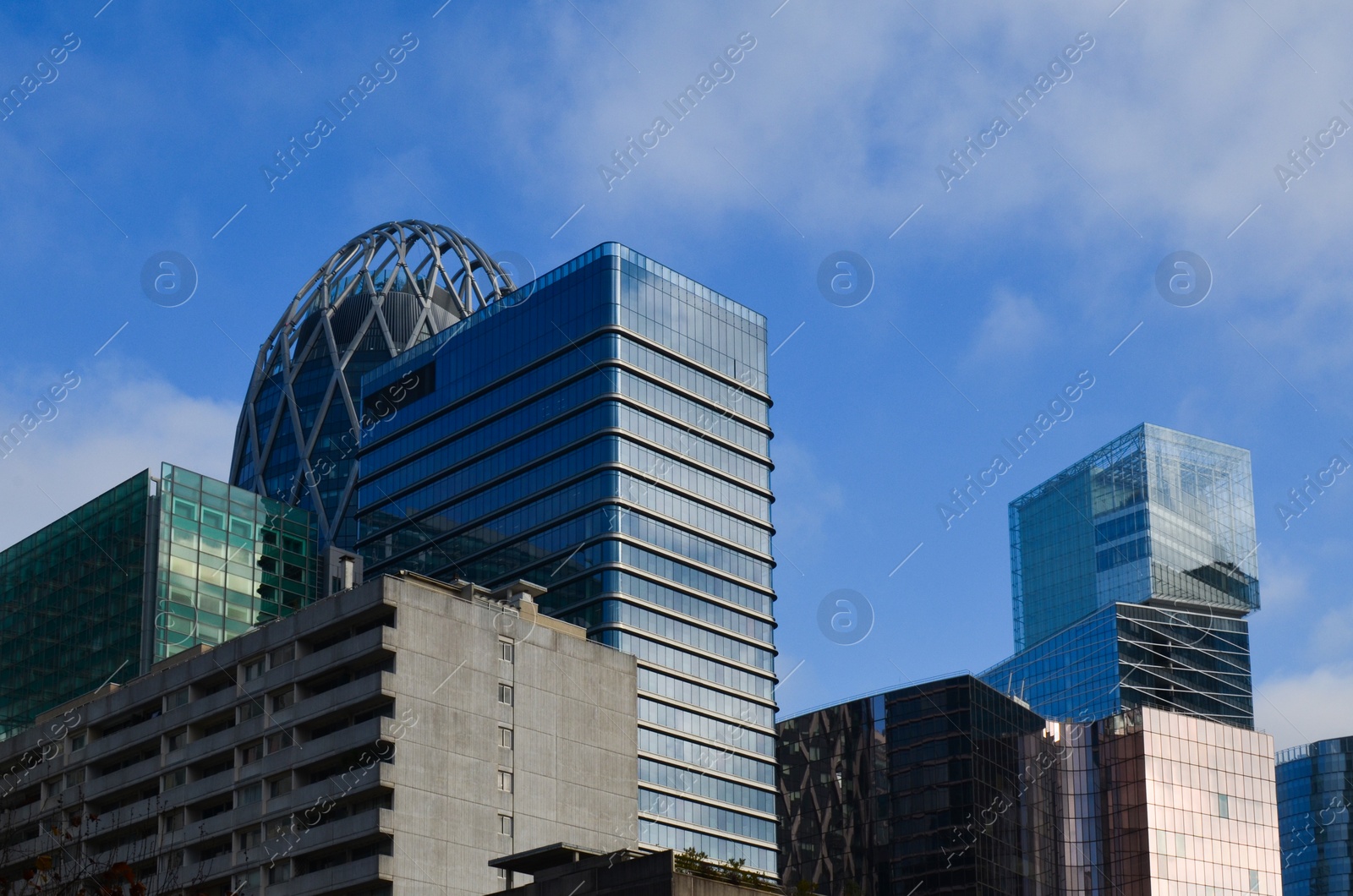 Photo of Exterior of different modern skyscrapers against blue sky