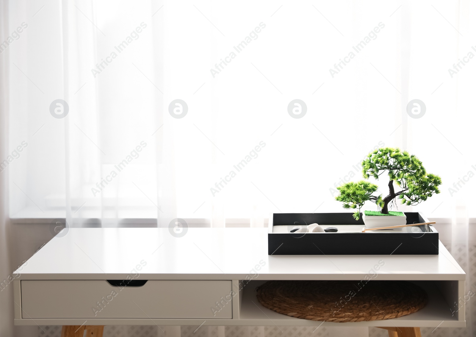 Photo of Beautiful miniature zen garden on white table indoors