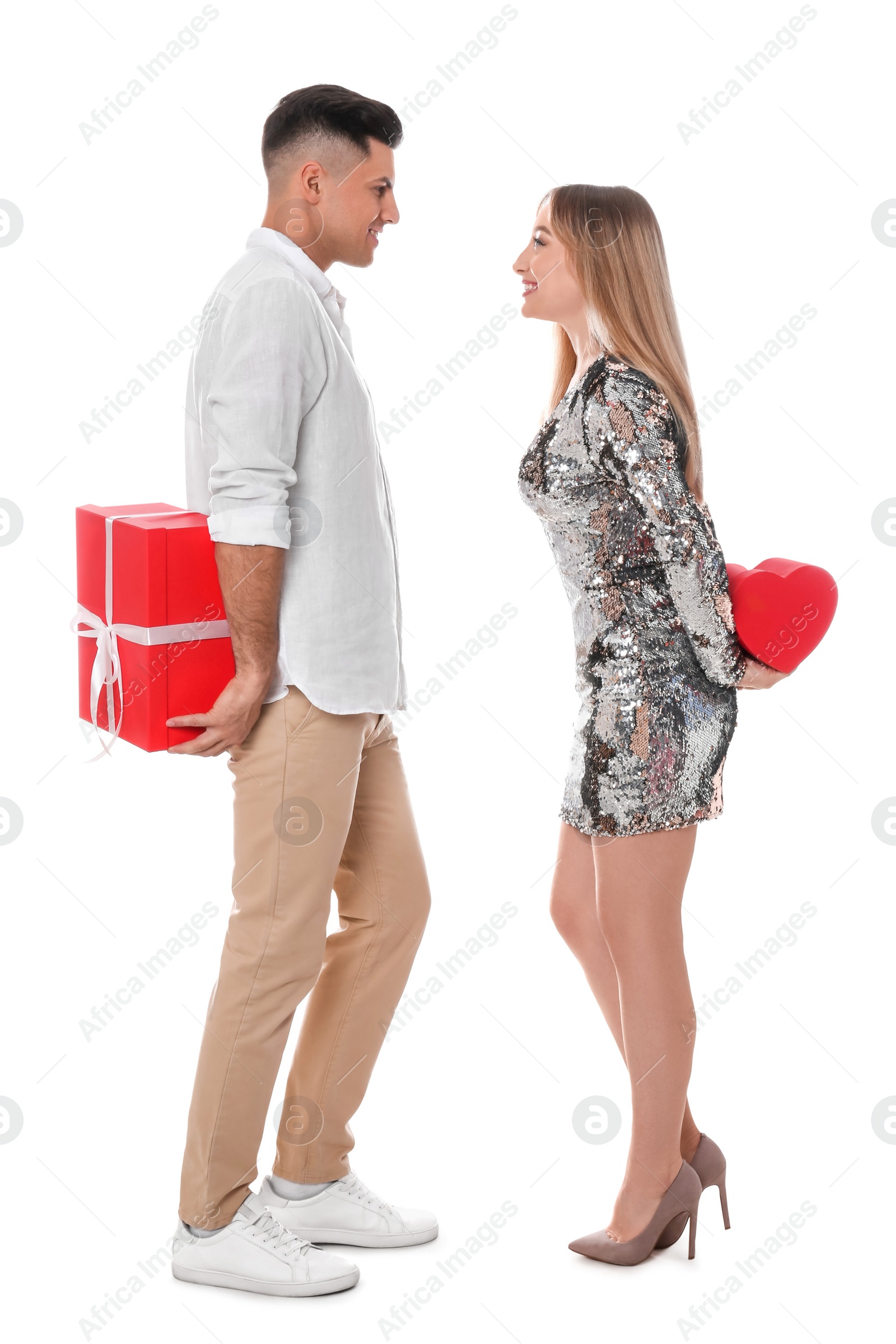 Photo of Lovely couple exchanging gifts on white background. Valentine's day celebration