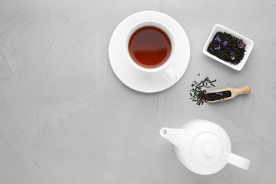 Composition with tea on grey background, flat lay. Space for text