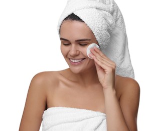 Photo of Young woman cleaning her face with cotton pad on white background