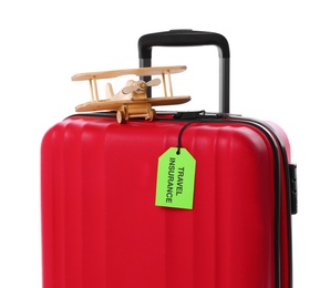 Red suitcase with TRAVEL INSURANCE label on white background
