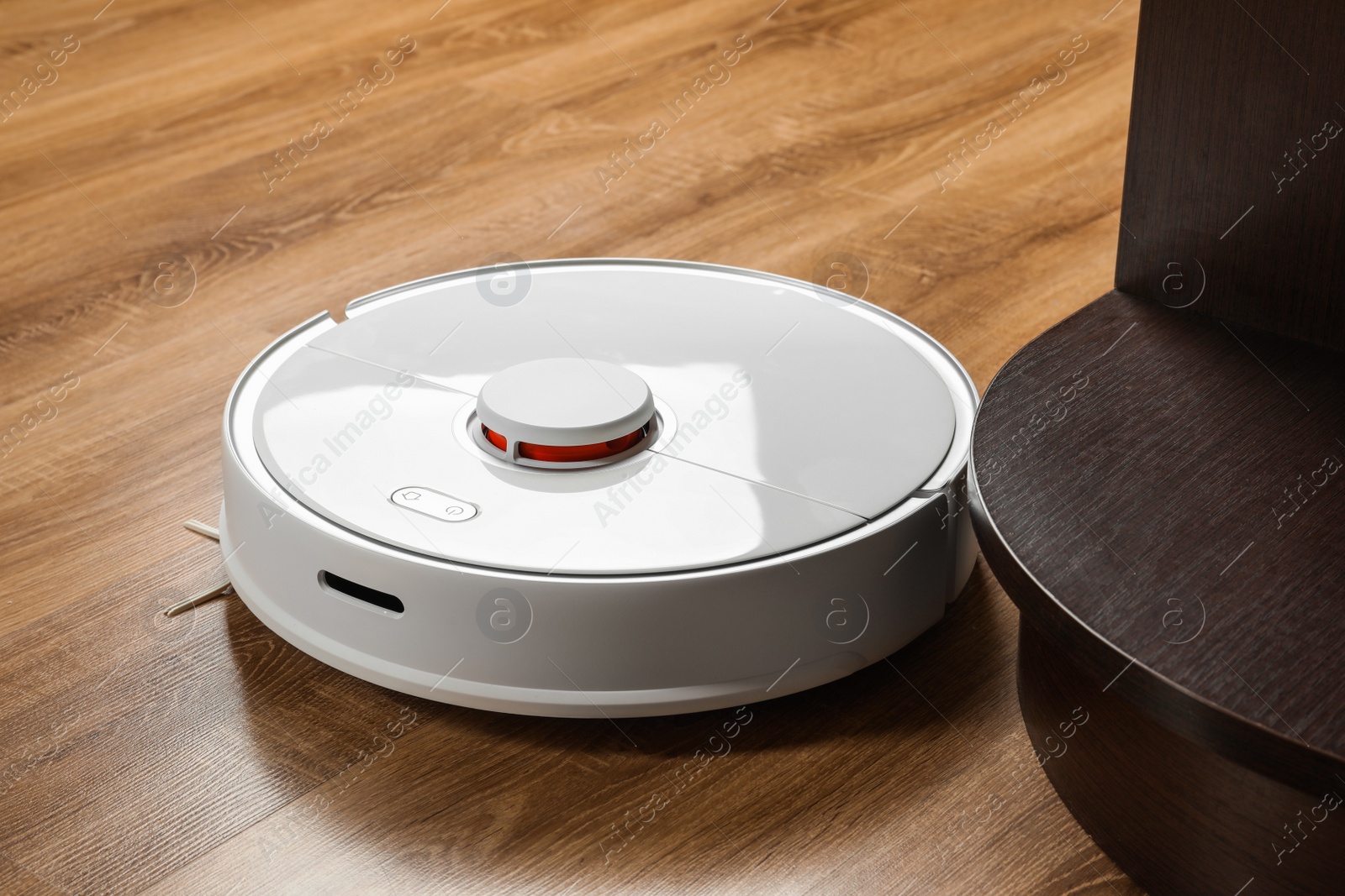 Photo of Robotic vacuum cleaner on wooden floor indoors