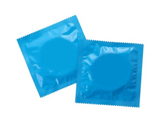 Photo of Condom packages isolated on white, top view. Safe sex