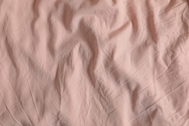 Photo of Crumpled pink fabric as background, top view