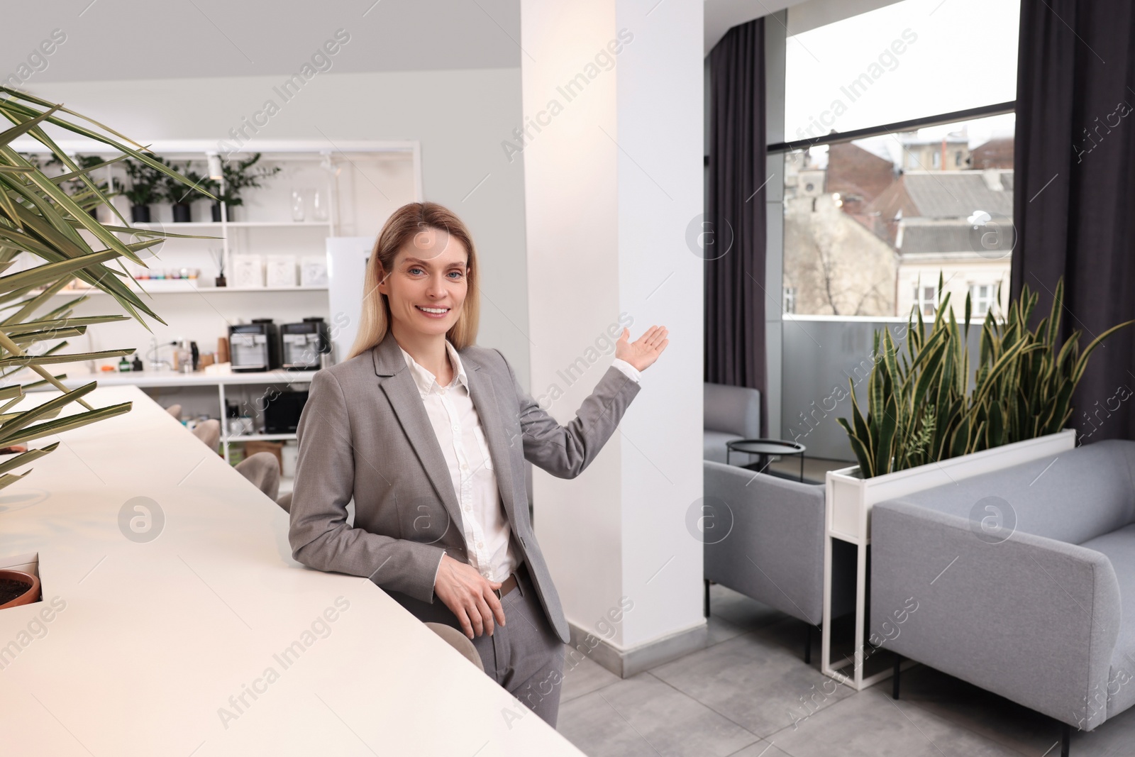 Photo of Happy female real estate agent in office