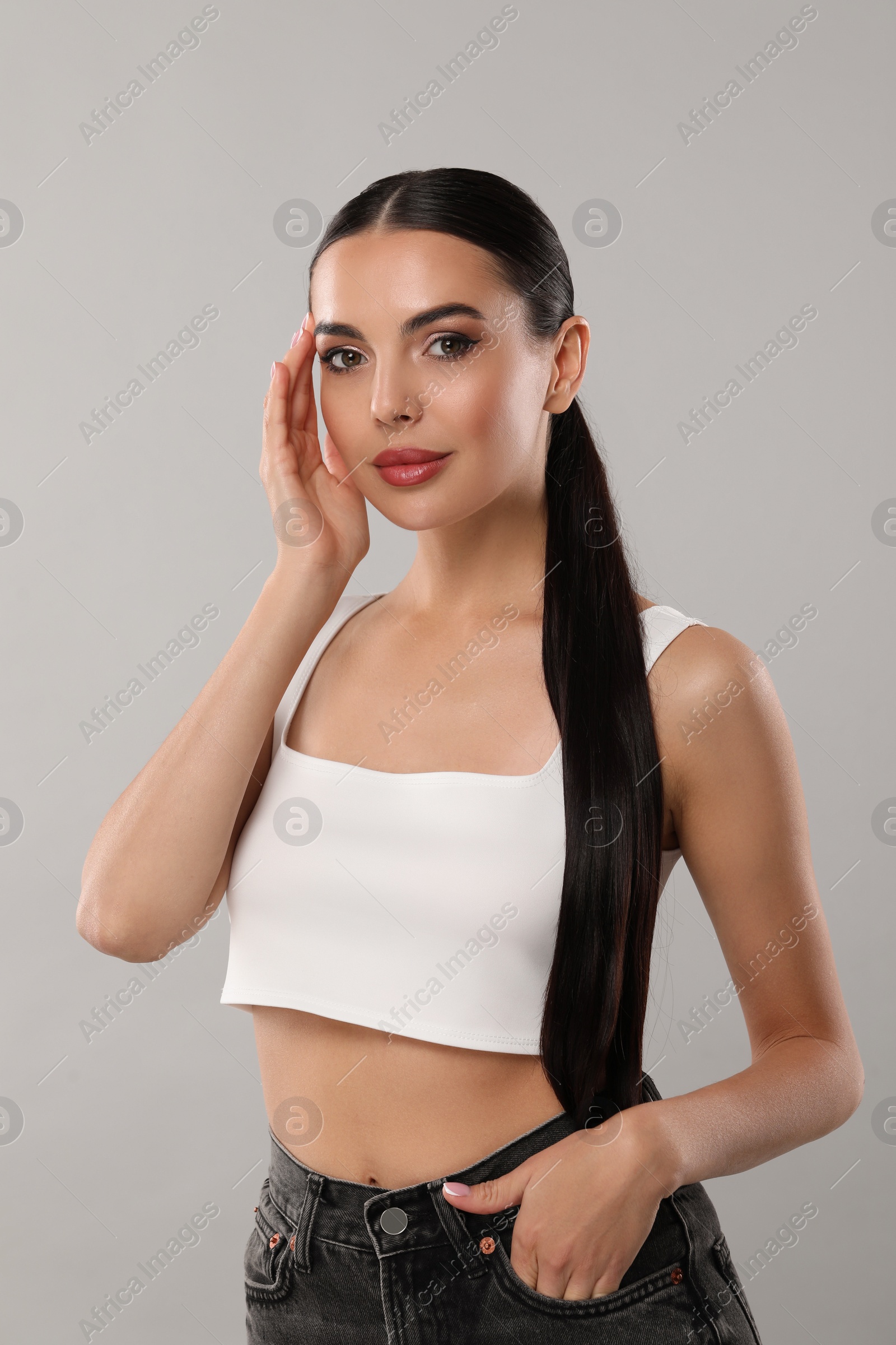 Photo of Beautiful woman wearing makeup on light grey background