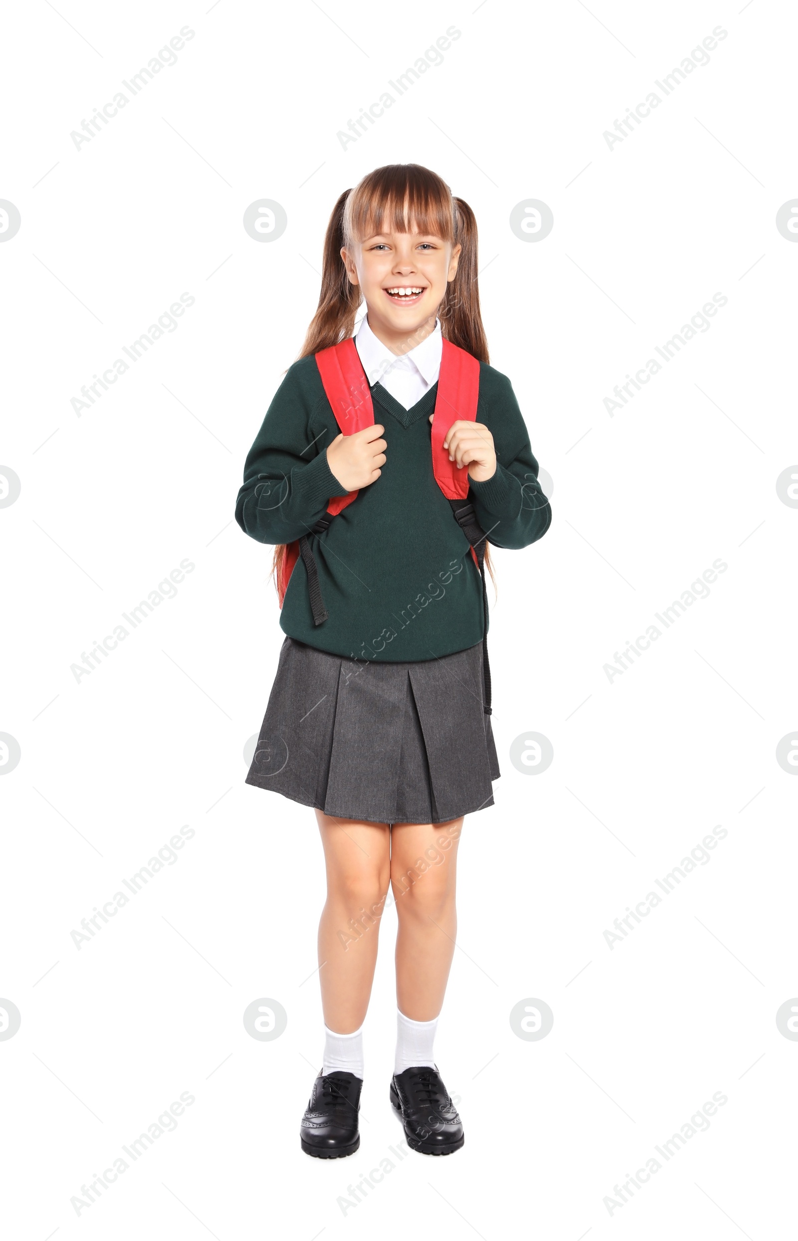 Photo of Little girl in stylish school uniform on white background