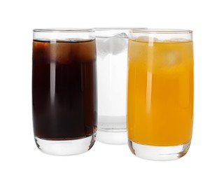 Photo of Glasses of different refreshing soda water with ice cubes on white background