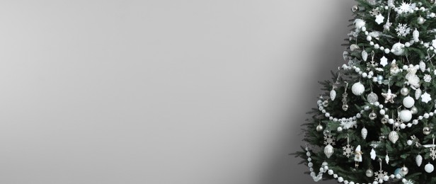 Image of Beautifully decorated Christmas tree on white background, space for text. Banner design
