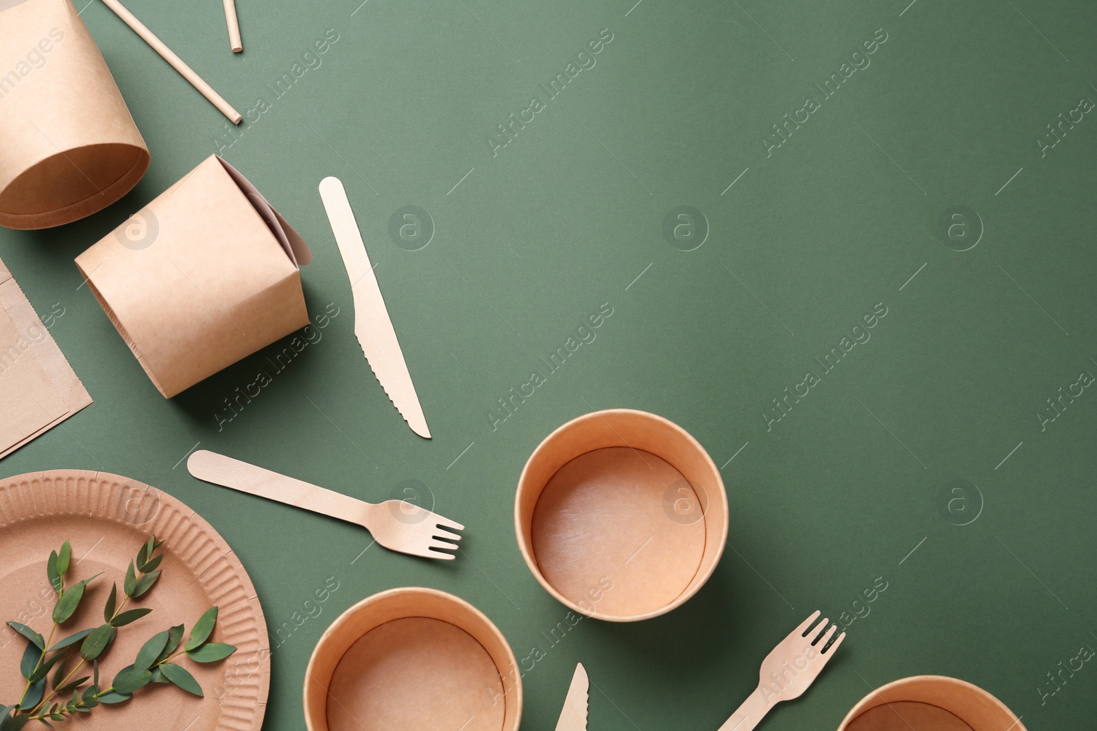 Photo of Disposable eco friendly products on olive background, flat lay. Space for text