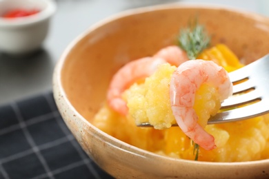 Photo of Eating of fresh tasty shrimp and grits, closeup