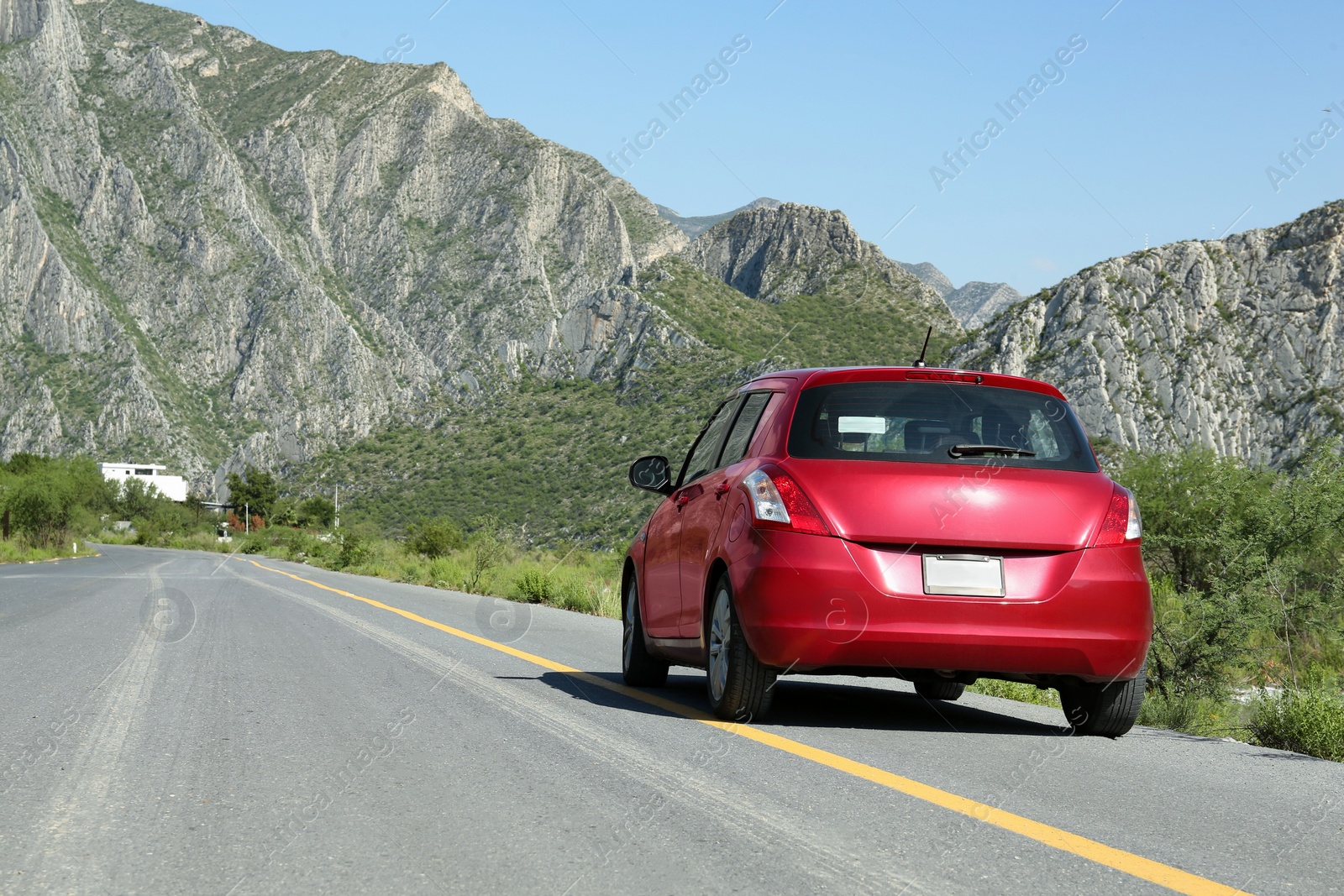 Photo of Beautiful view of car on asphalt highway in mountains. Road trip