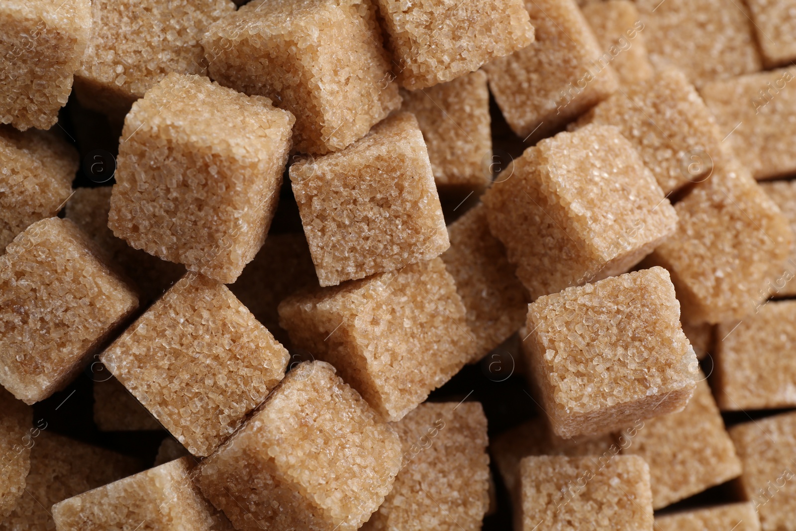 Photo of Brown sugar cubes as background, closeup view