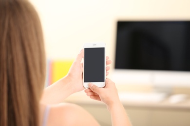 Woman using smartphone indoors, closeup. Mock up for design