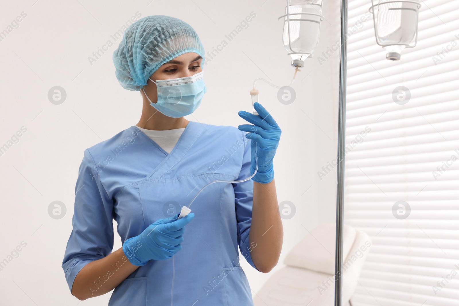 Photo of Nurse setting up IV drip in hospital