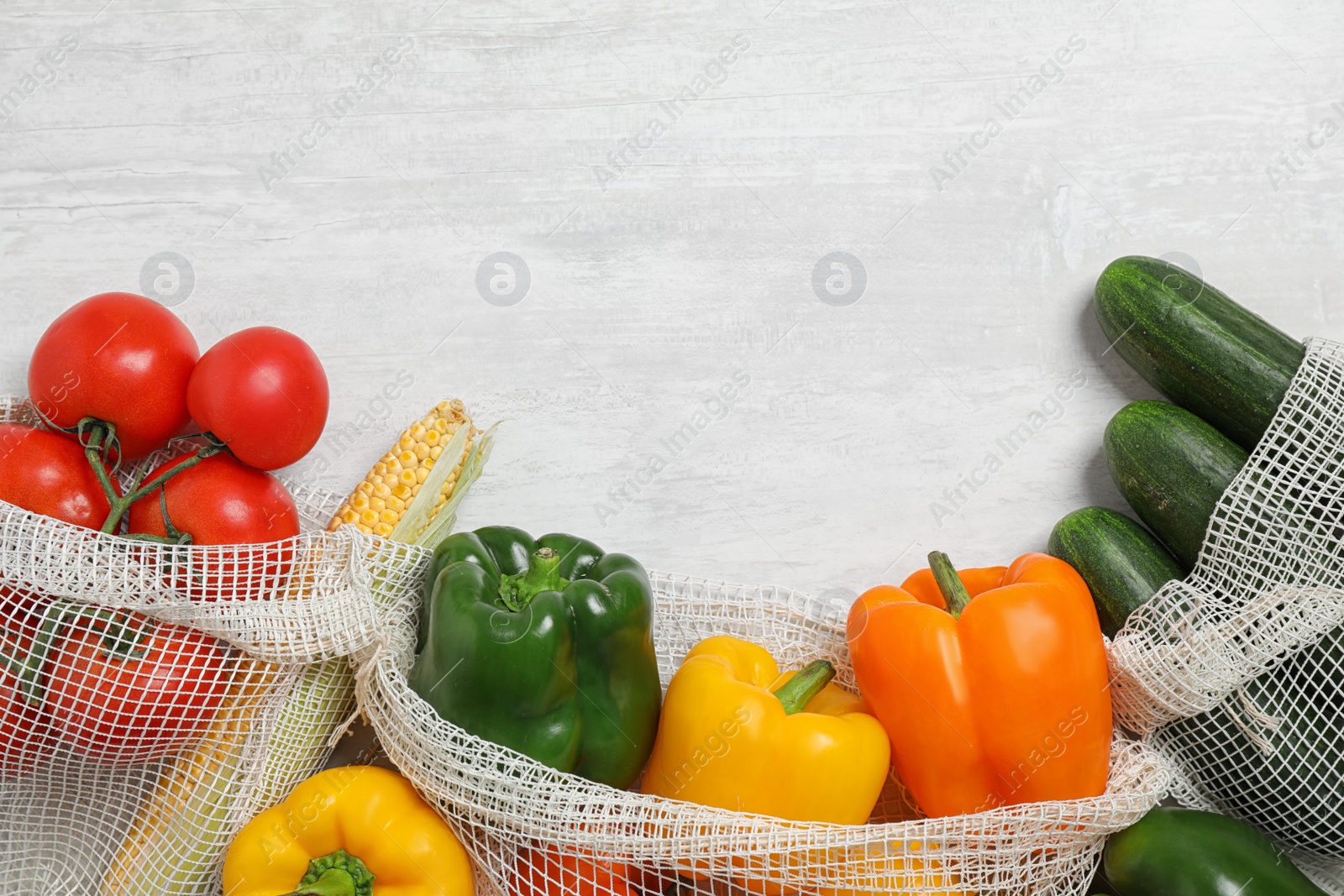Photo of Fresh vegetables on light grey background, flat lay. Space for text