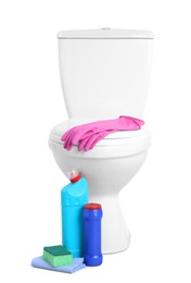 Toilet bowl and different cleaning supplies on white background