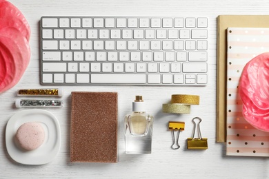 Creative flat lay composition with tropical flowers and computer keyboard on wooden background