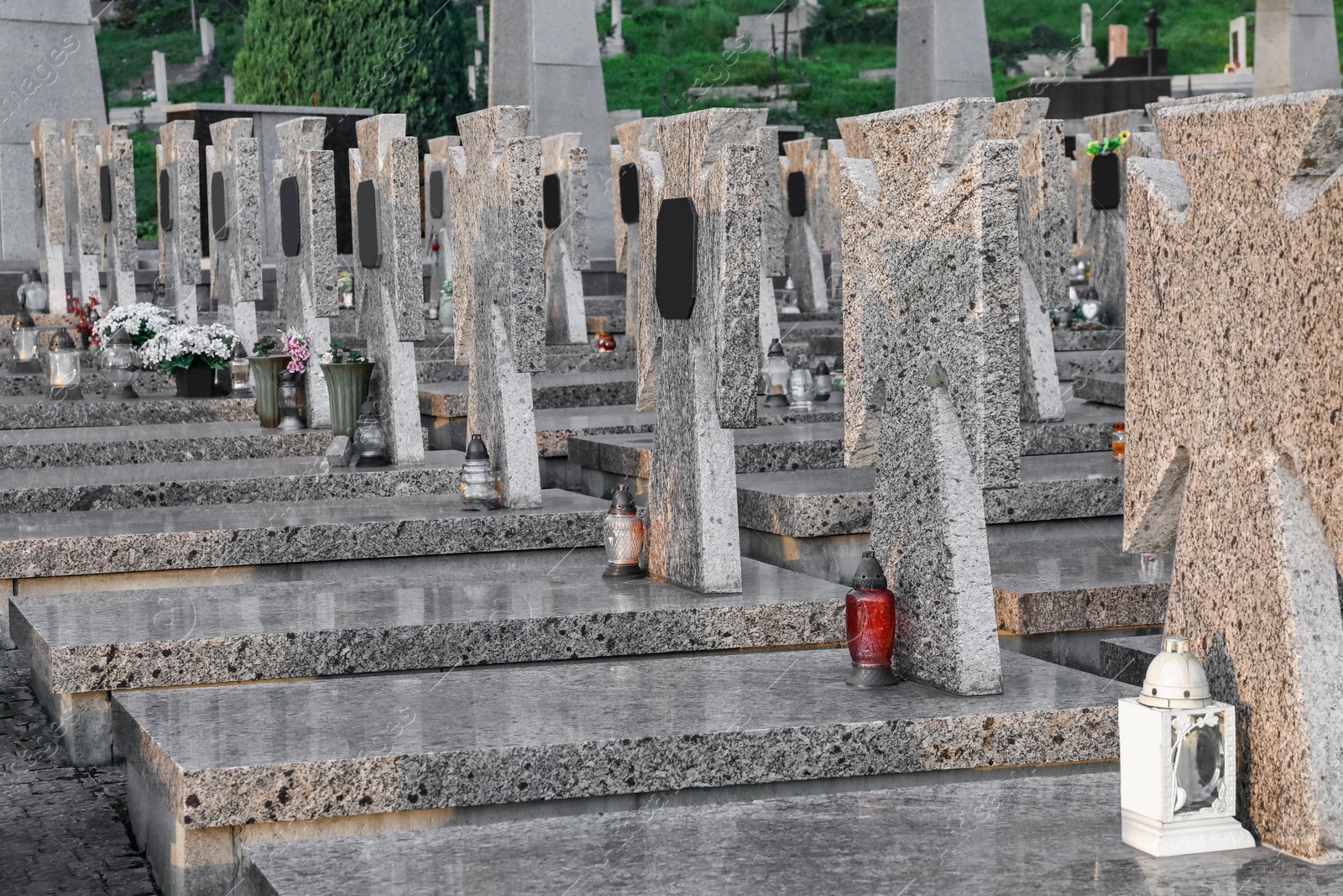 Photo of Many granite tombstones on cemetery. Funeral ceremony