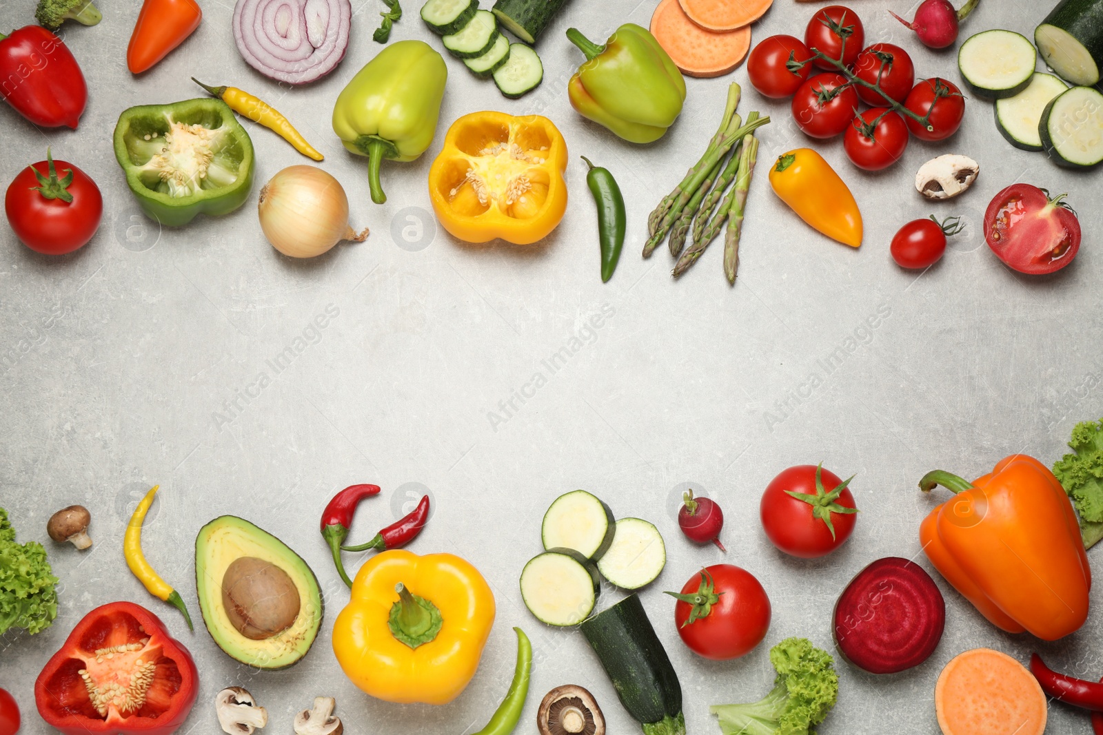 Photo of Frame of fresh vegetables on grey table, flat lay. Space for text