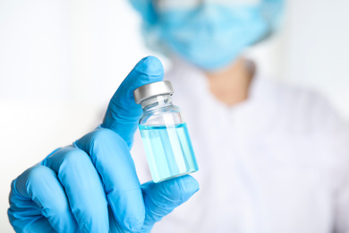 Doctor holding vial with medication, closeup. Vaccination and immunization