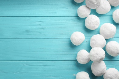 Photo of Snowballs on light blue wooden background, flat lay. Space for text