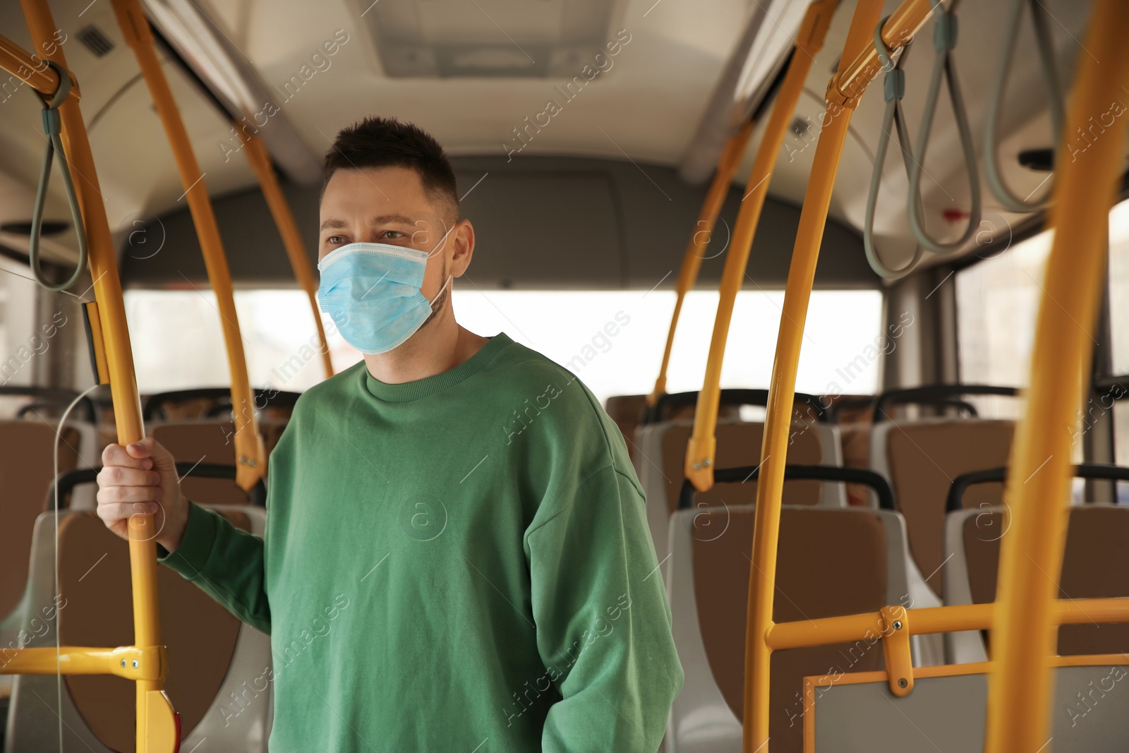 Photo of Man with disposable mask on bus. Virus protection