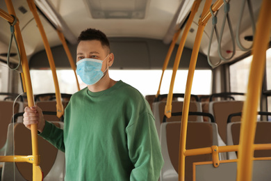Man with disposable mask on bus. Virus protection