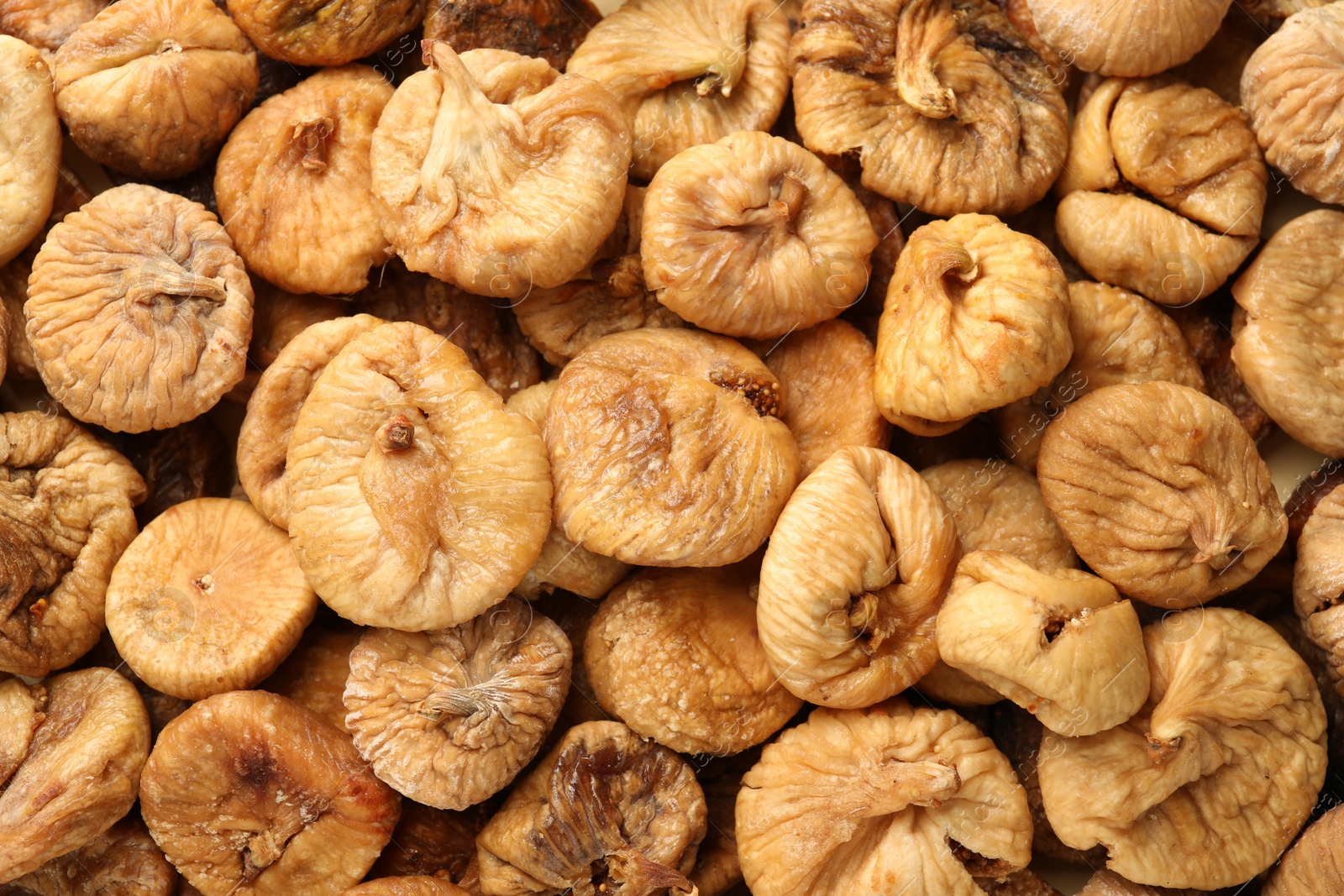 Photo of Many tasty dried figs as background, top view