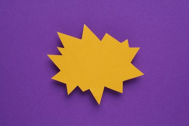 Photo of Paper bursting speech star on purple background, top view. Space for text