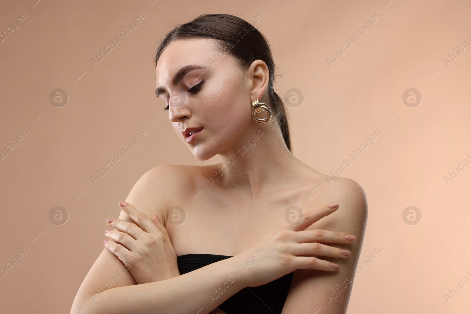 Photo of Portrait of beautiful young woman on beige background