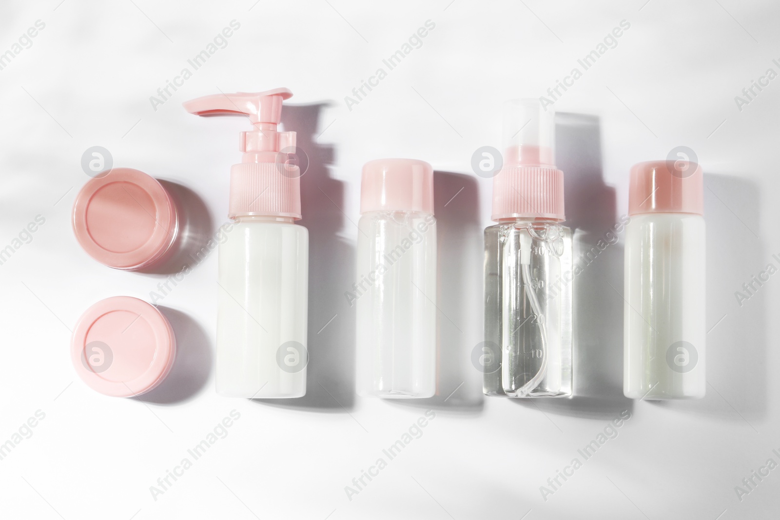 Photo of Cosmetic travel kit on white background, top view