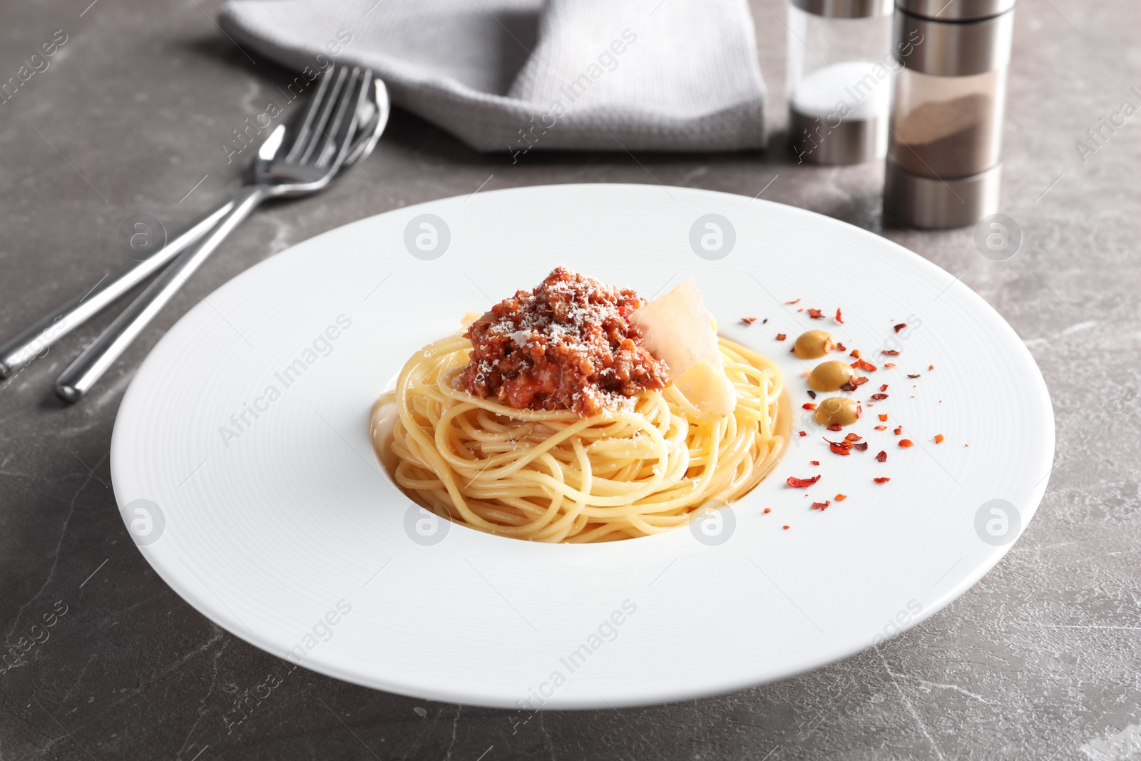 Photo of Plate with delicious pasta bolognese on table