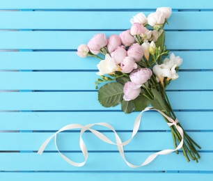 Photo of Bouquet of beautiful flowers on wooden background, top view