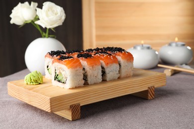 Photo of Delicious sushi rolls with salmon served on table