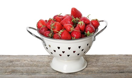 Photo of Colander with fresh strawberries on wooden table against white background