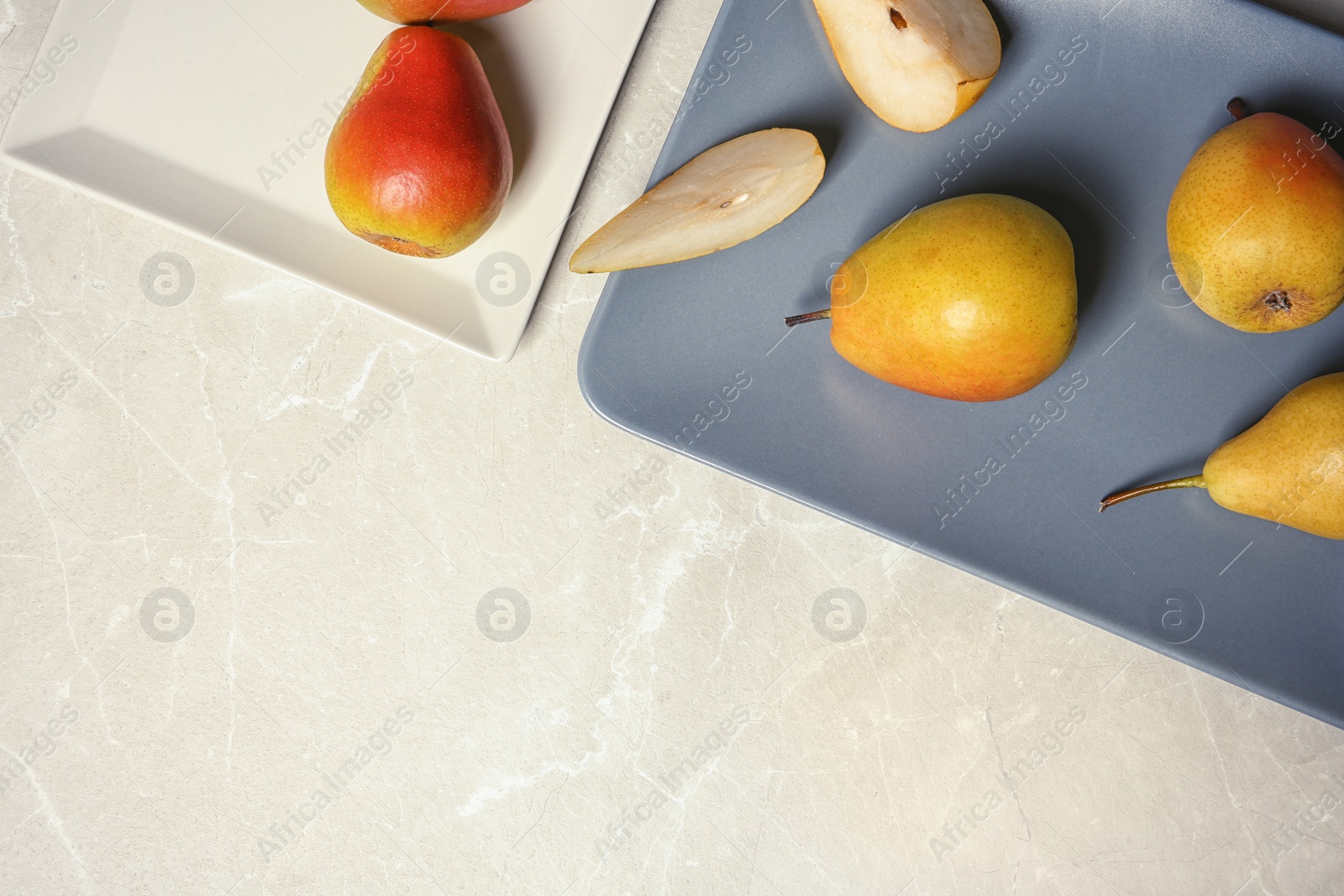 Photo of Flat lay composition with ripe pears on grey background. Space for text