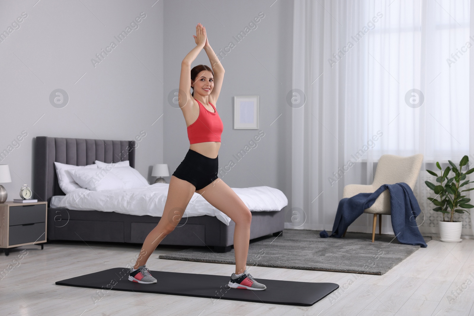 Photo of Happy woman doing morning exercise at home