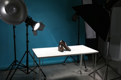 Photo of Shooting of men's shoes for product promotion in photo studio