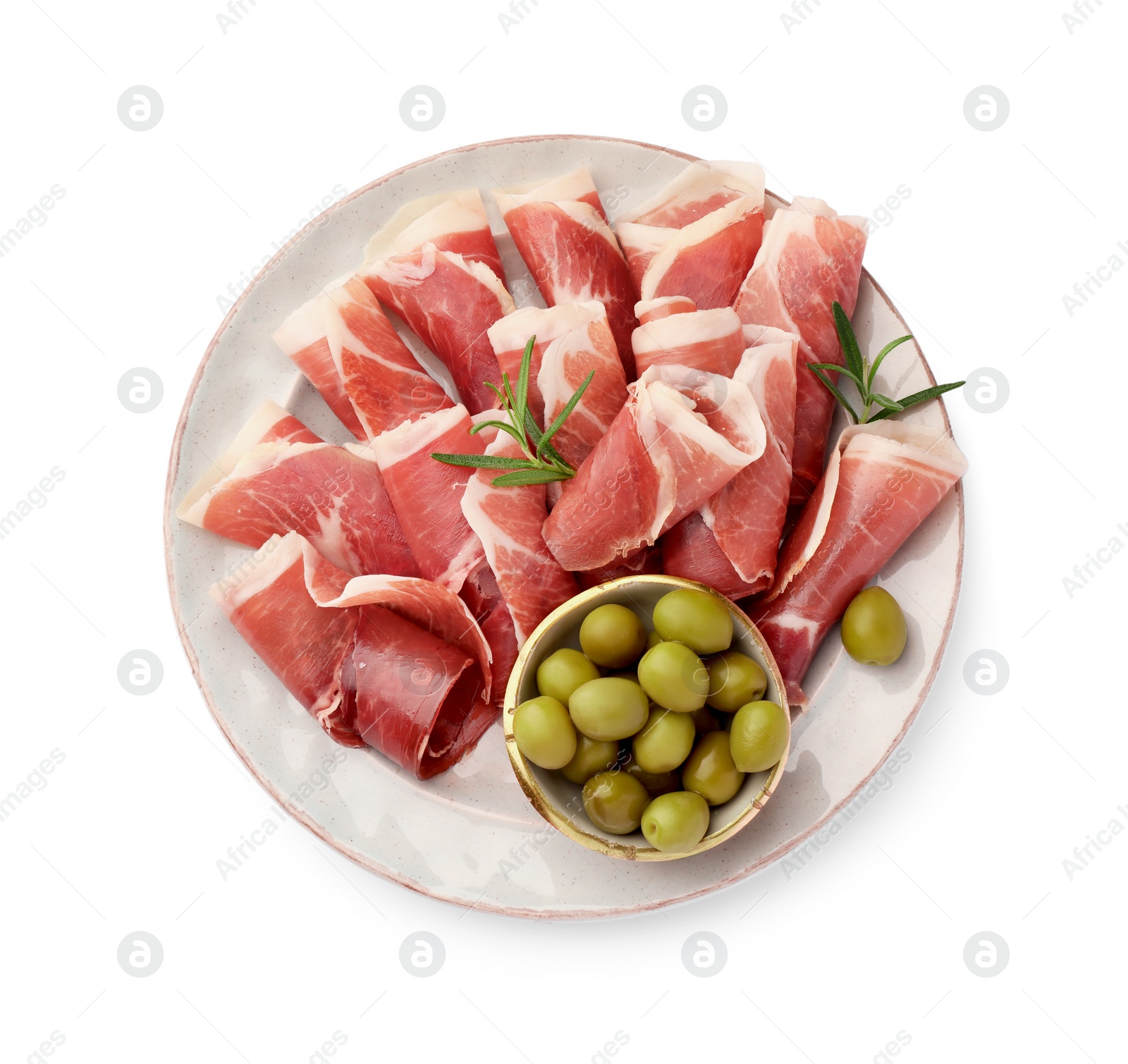 Photo of Plate with rolled slices of delicious jamon, olives and rosemary isolated on white, top view