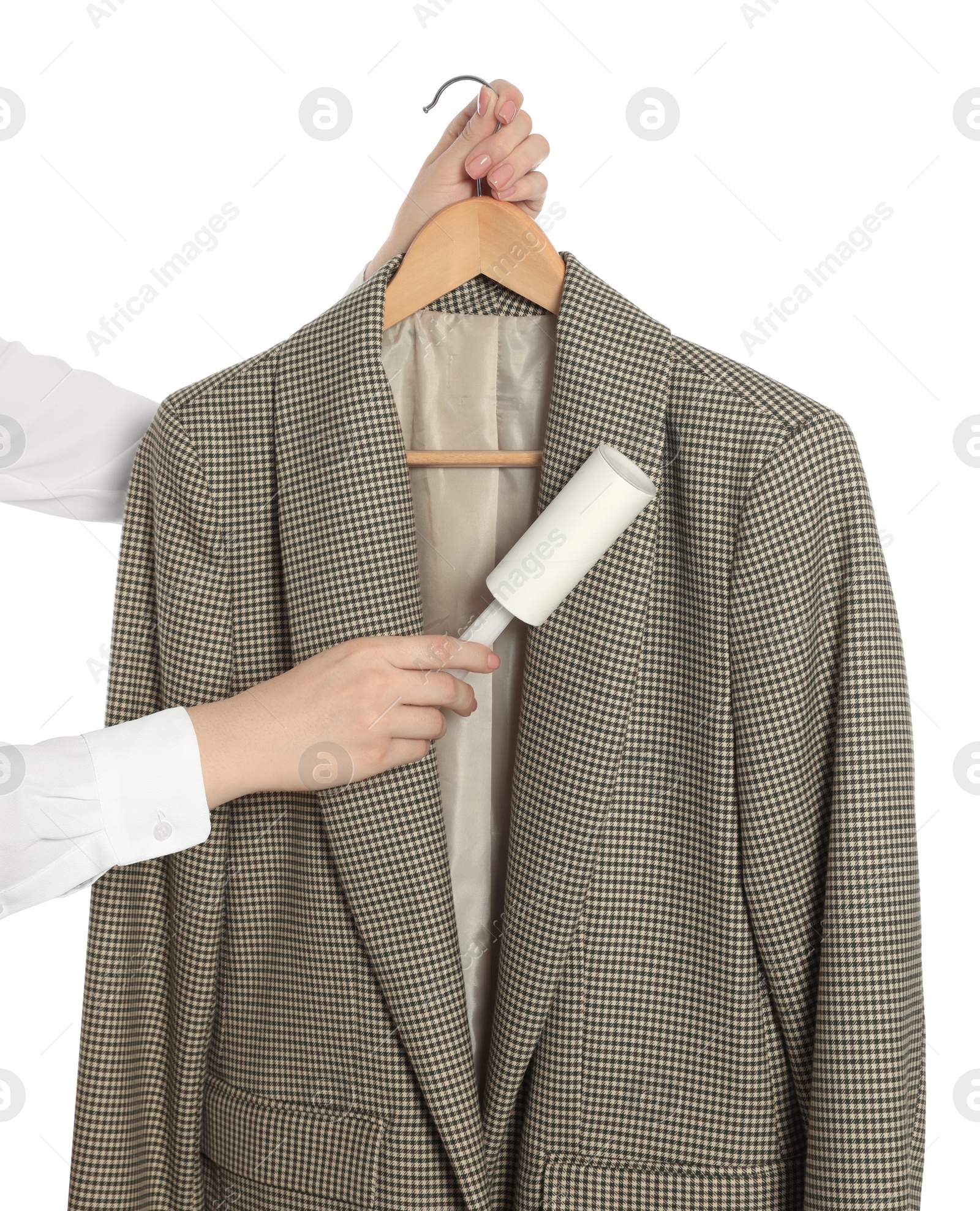 Photo of Woman cleaning suit with lint roller on white background, closeup