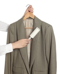 Woman cleaning suit with lint roller on white background, closeup