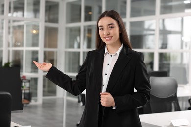 Happy female real estate agent in office