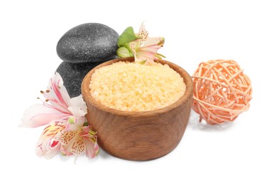 Photo of Orange sea salt in bowl, spa stones, rattan ball and floral decor isolated on white