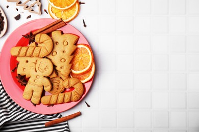Flat lay composition with tasty different cookies, spices and cutter on white table, space for text