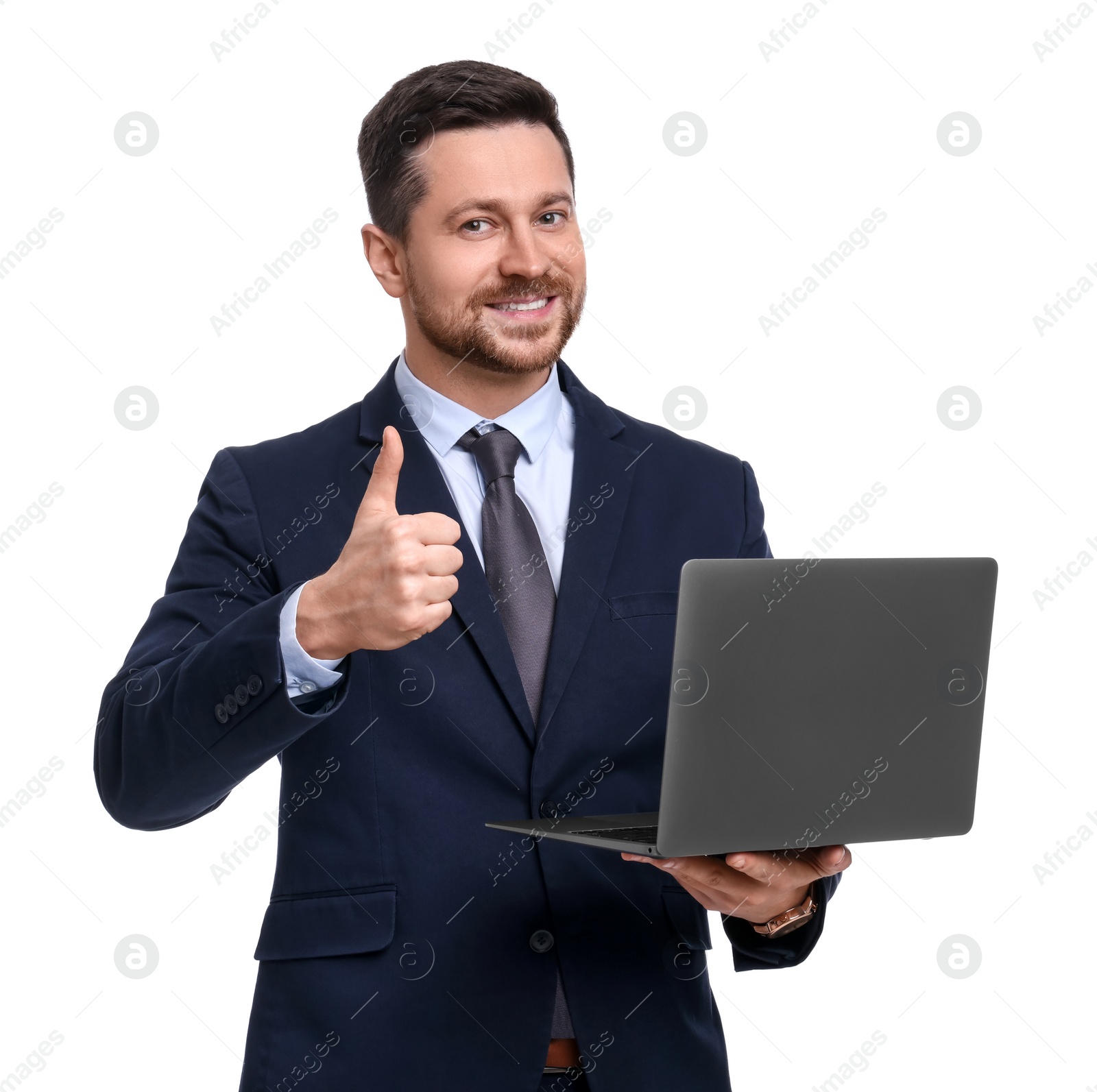 Photo of Handsome bearded businessman in suit with laptop showing thumb up on white background