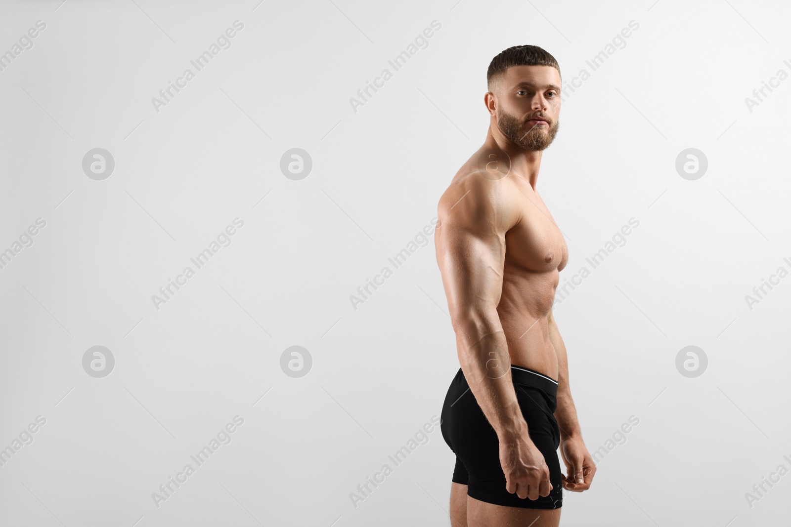 Photo of Young man is stylish black underwear on light grey background. Space for text