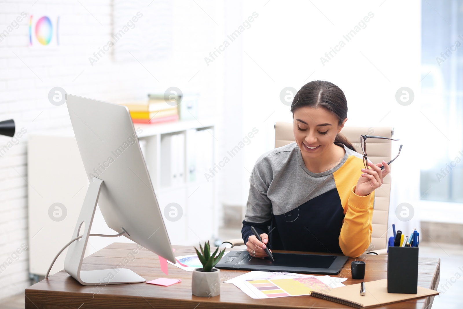 Photo of Female designer working at desk in office